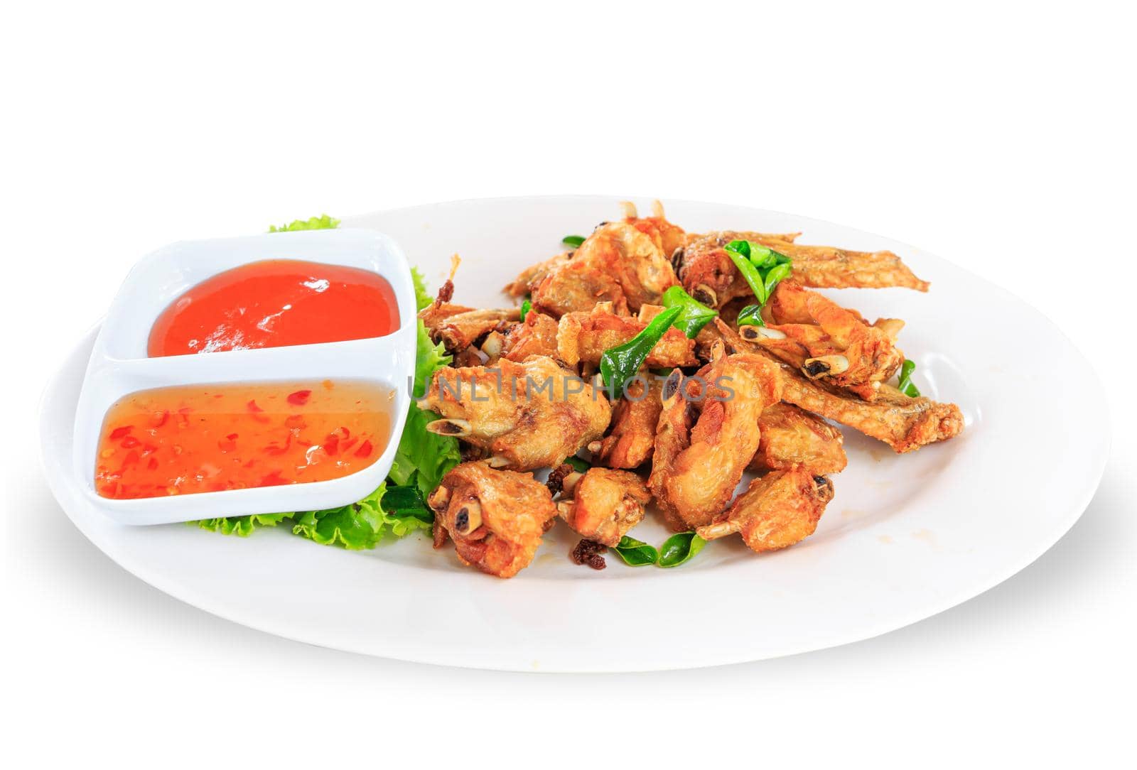 Fried chicken wings with sauce in white plate on white background