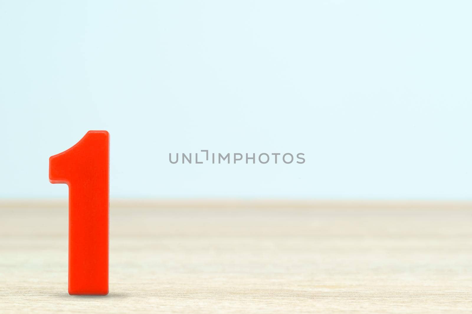 Shot of a number one made of red plastic on table with copy space