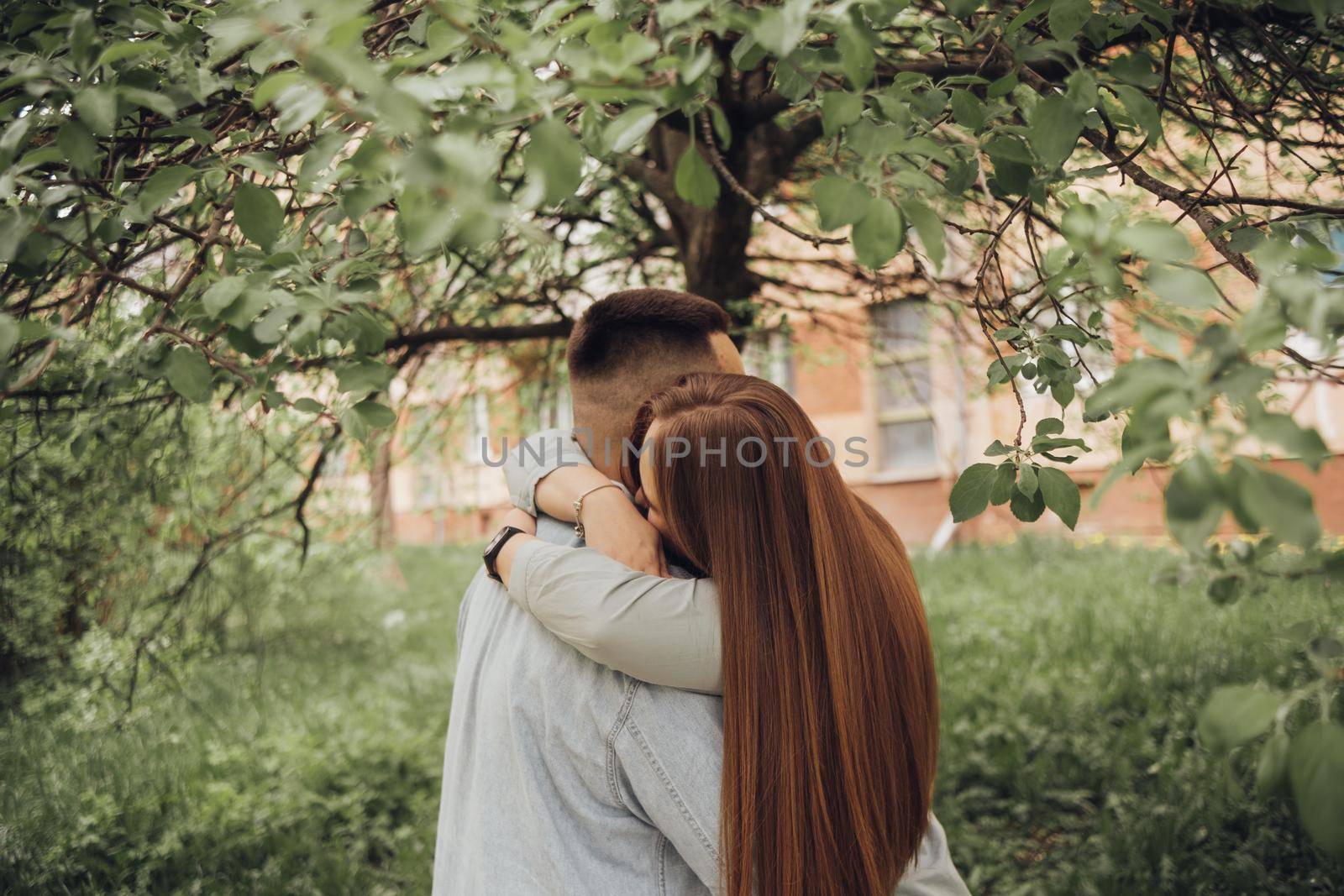 lovers embrace under a tree by Symonenko