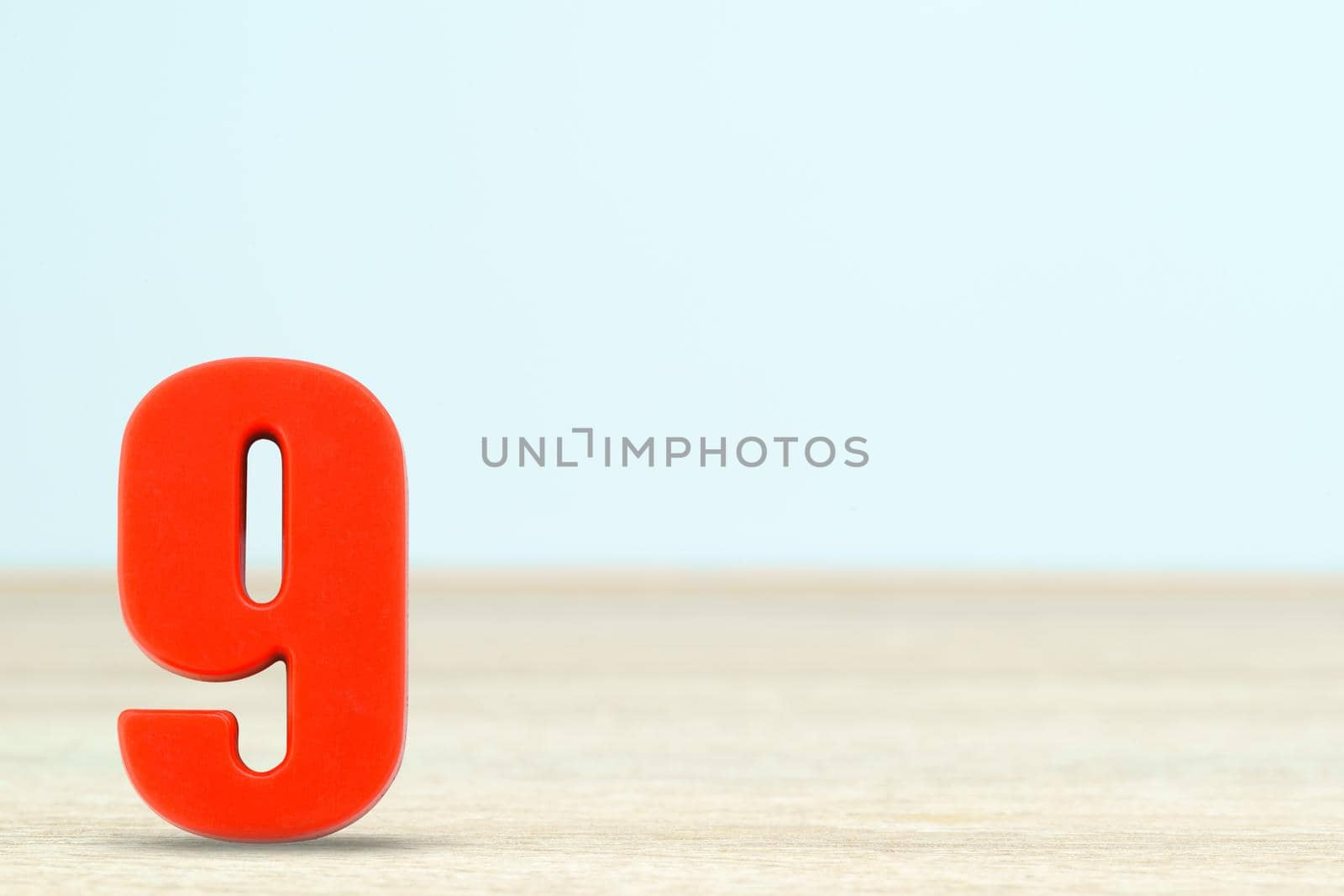 Shot of a number nine made of red plastic on table with copy space