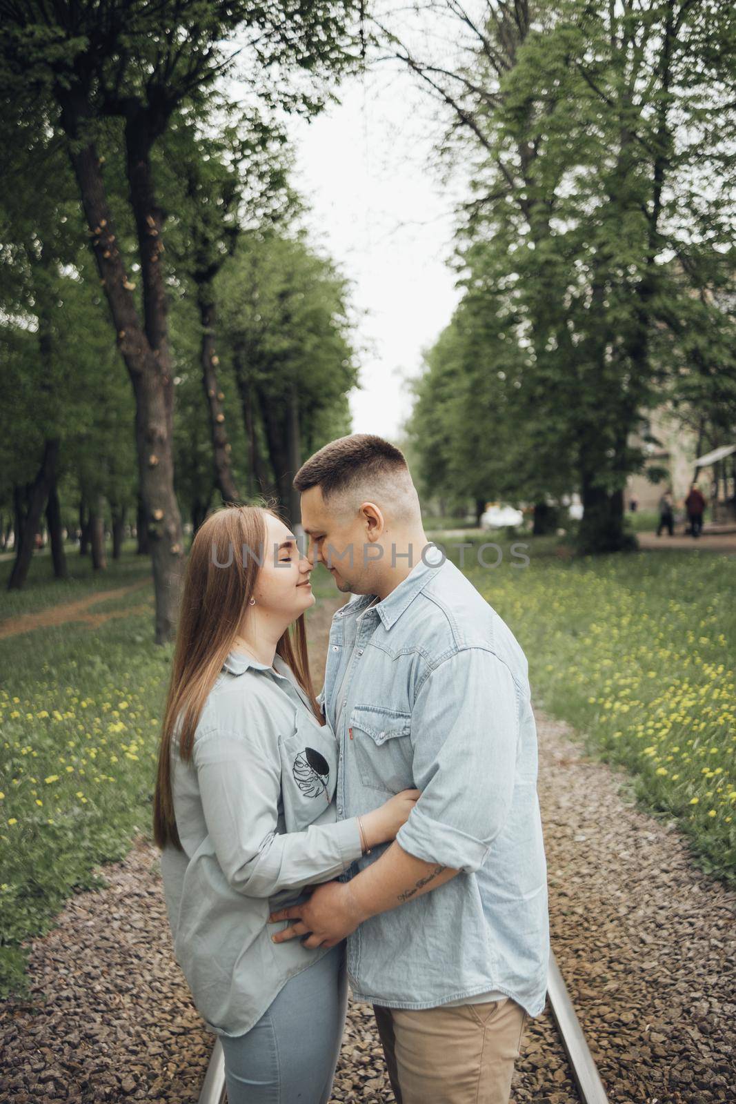 loving couple walking in ukrainian park and city