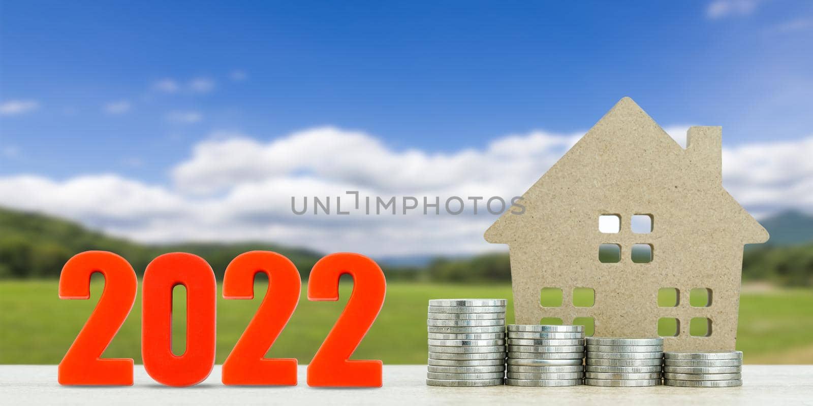 House model and stack of coins with landscape back background for finance and banking concept