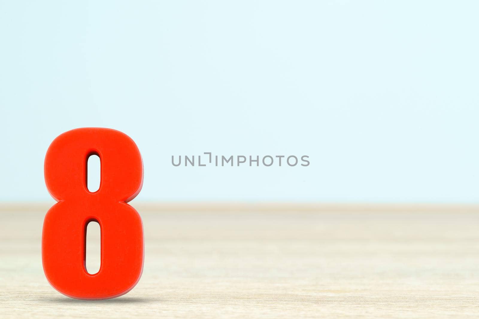 Shot of a number eight made of red plastic on table with copy space