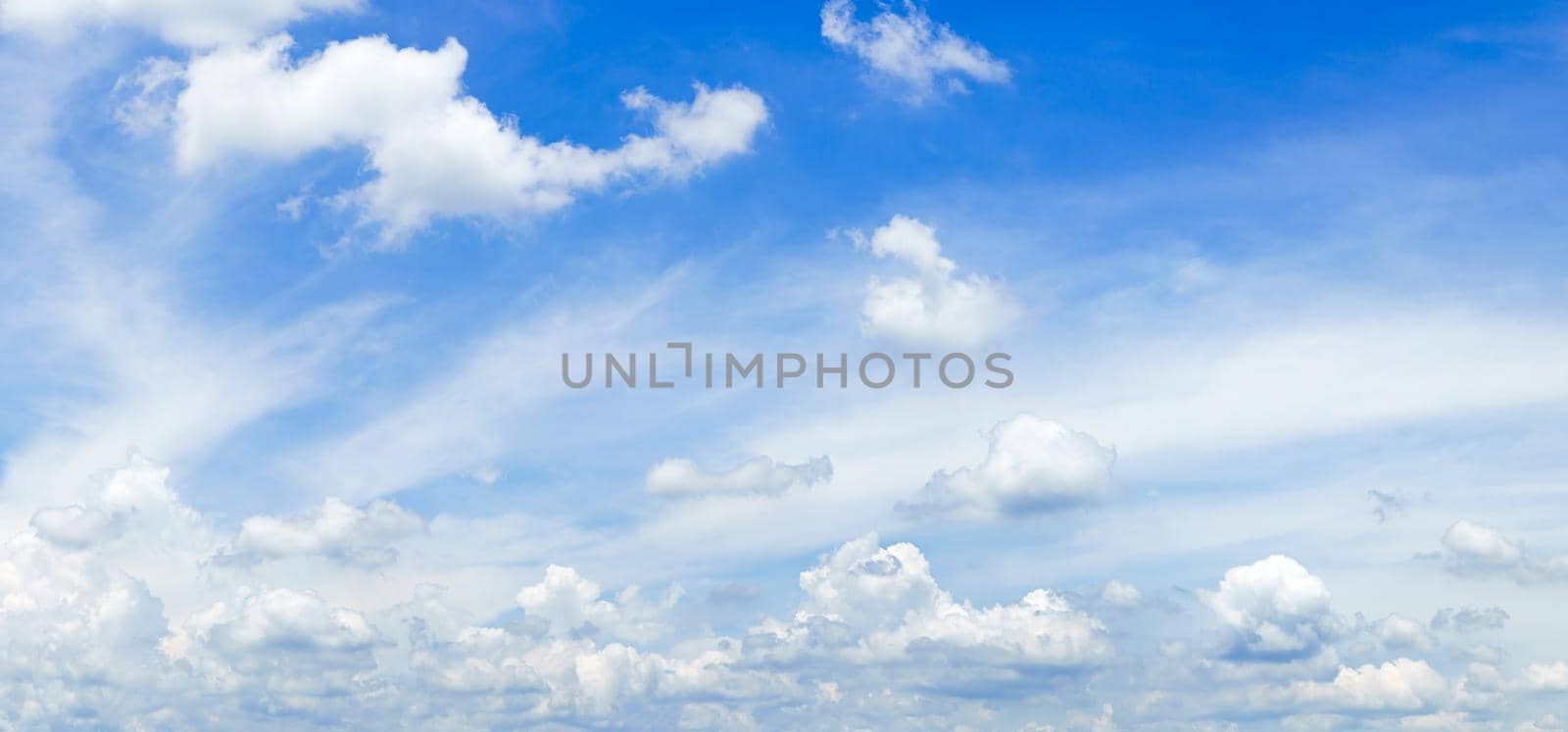 Panorama fluffy clouds against in blue sky by stoonn