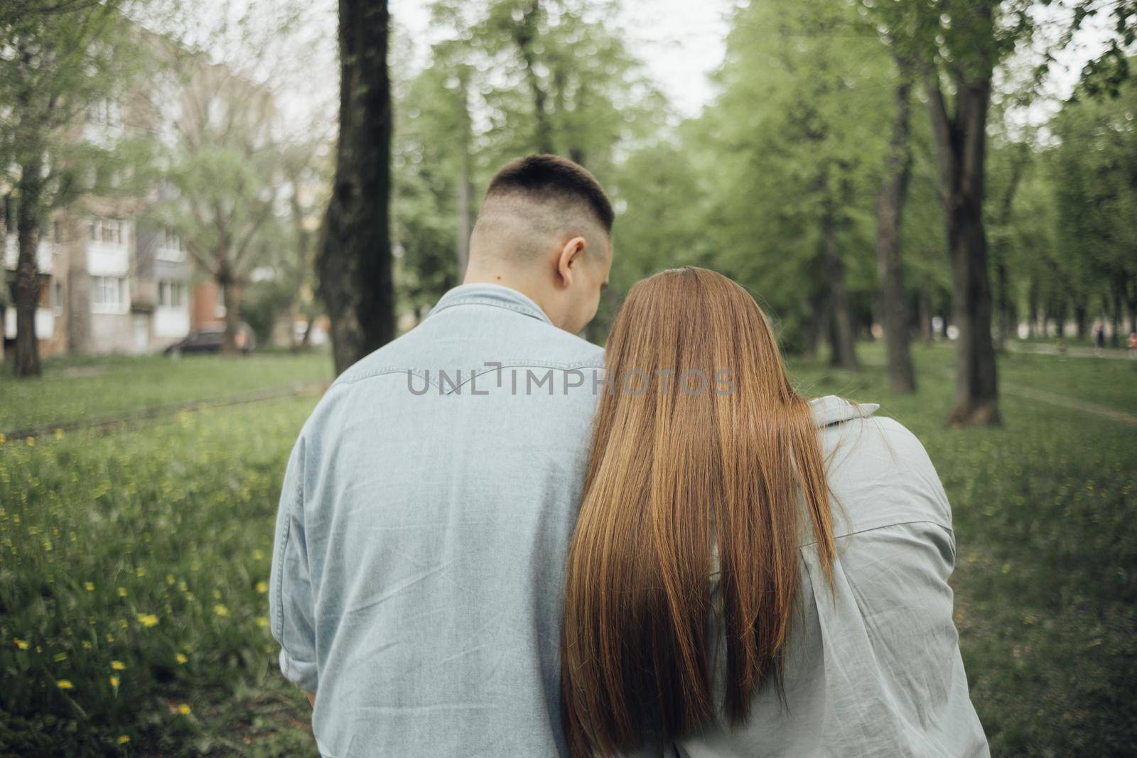 loving couple walking in ukrainian park and city