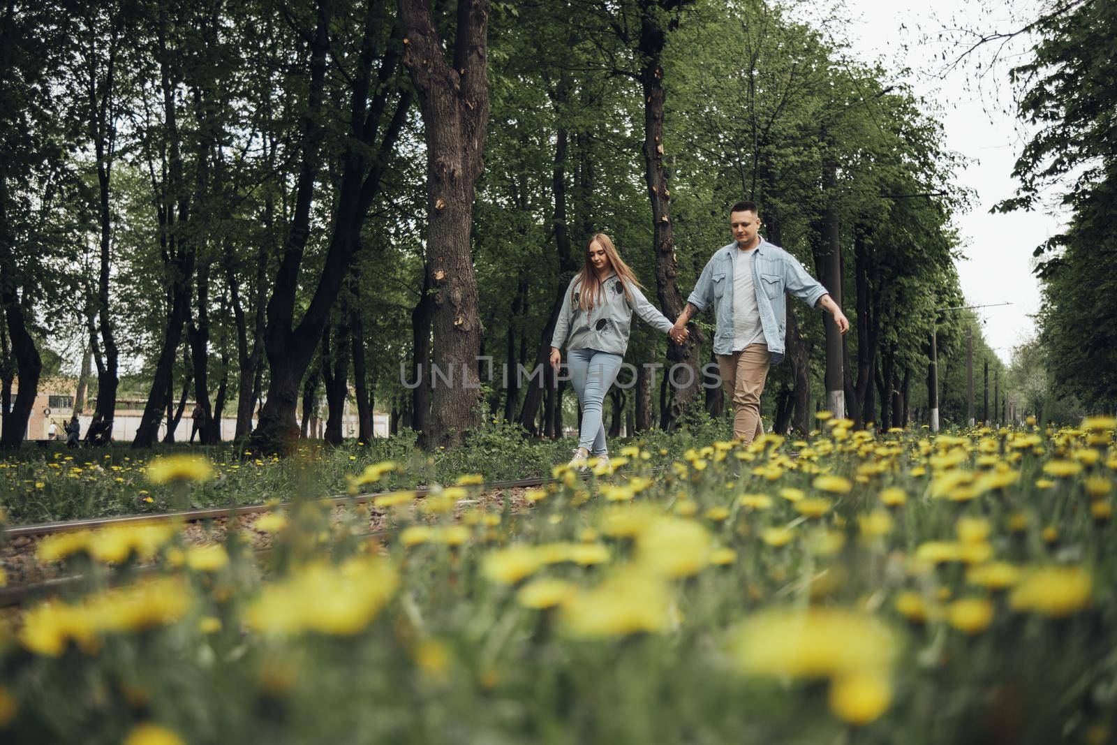 loving couple walking in ukrainian park and city