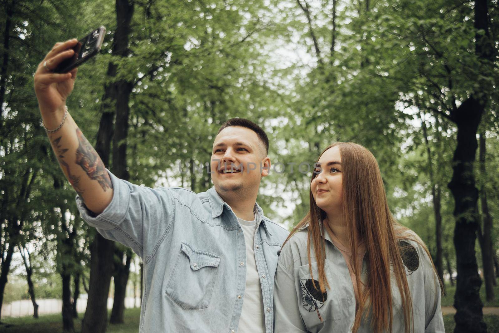 loving couple walking in ukrainian park and city