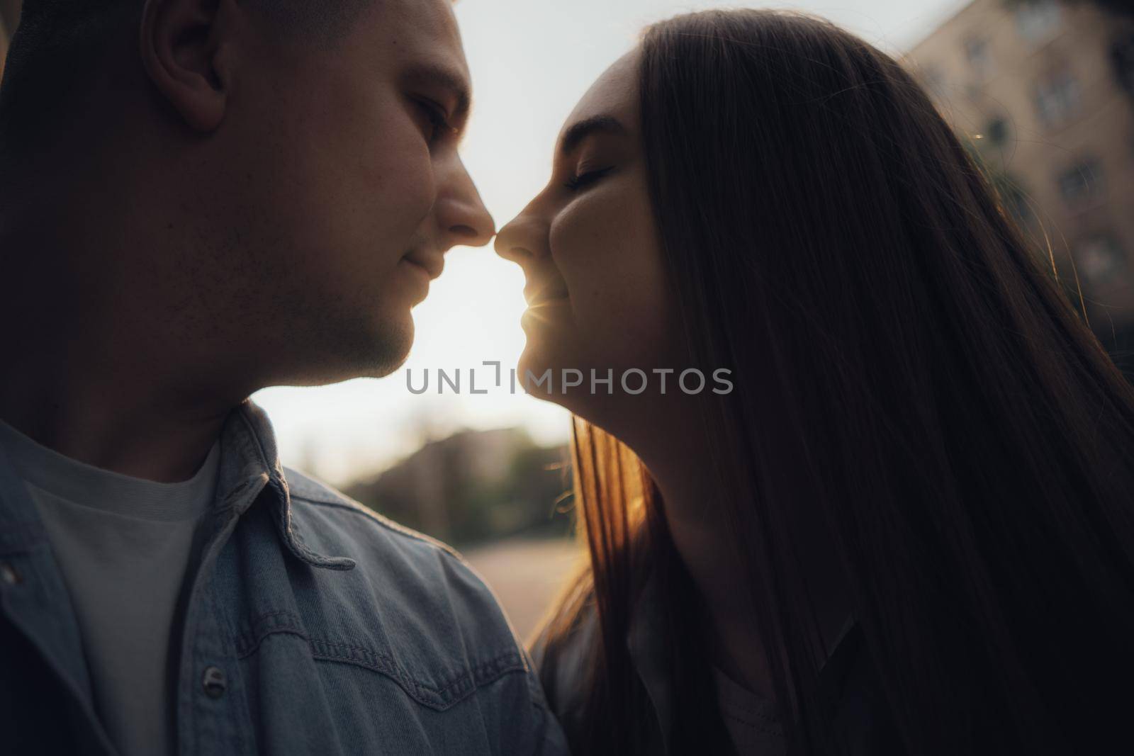 a couple kissing at sunset. Close-up by Symonenko