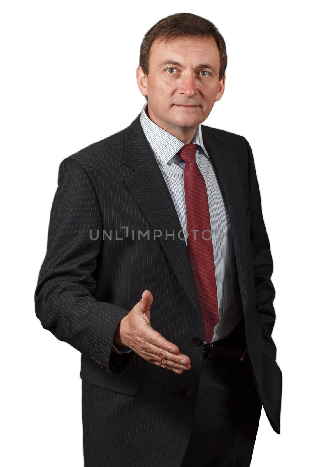 Confident and friendly elegant handsome mature businessman in a studio giving a hand for greetings on white isolated background