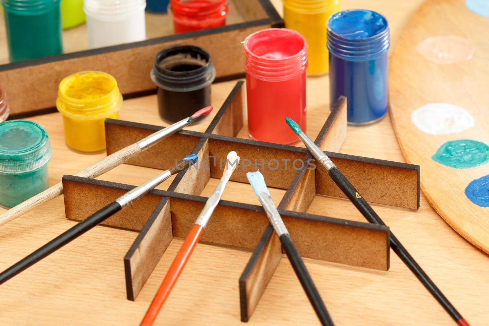 Paints and brushes on the desk ready for painting by mvg6894