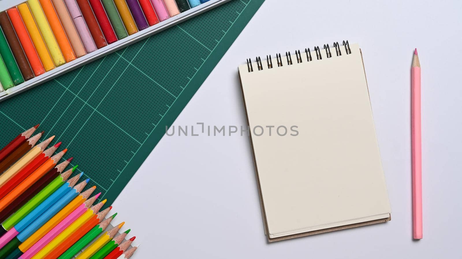 Notebook with school supplies on white table . Back to school. concept.