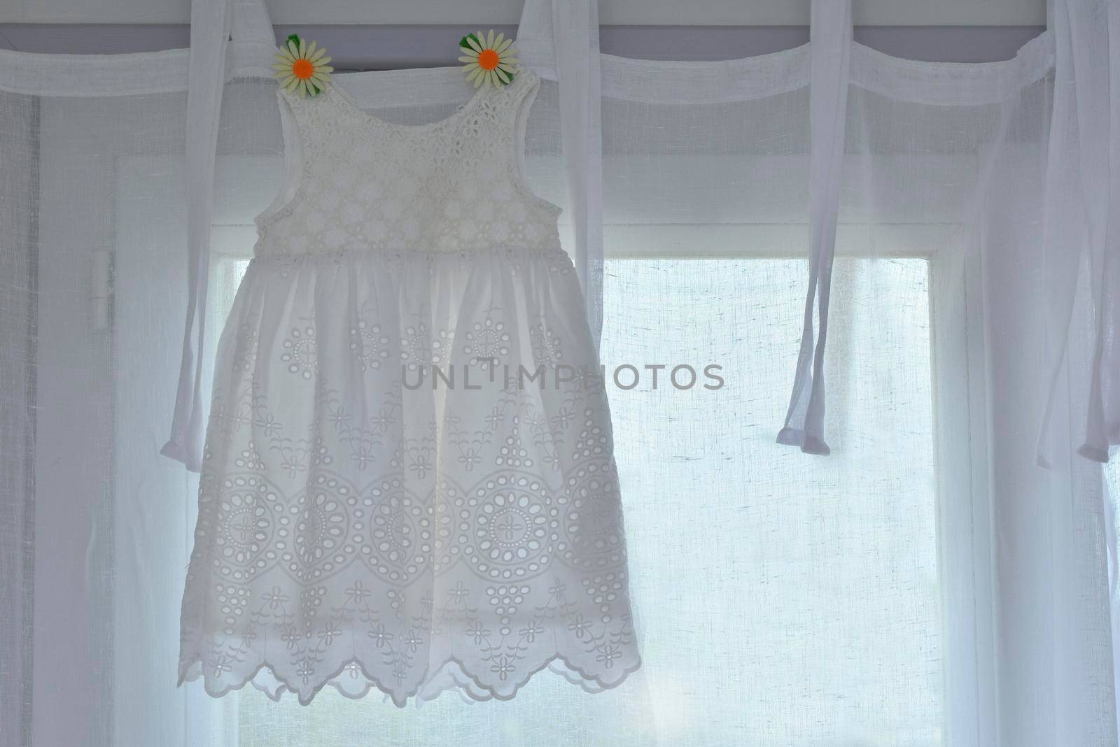 white dress for girl hanging for birthday celebration