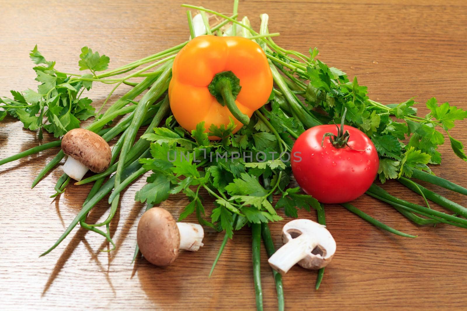 Set of good natural products with fresh pepper, tomato, mushrooms, onion and parsley on the table