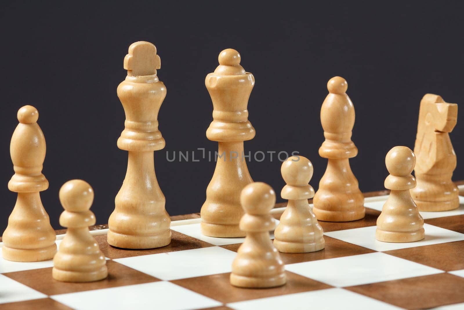 Chess board with chess pieces on gray background