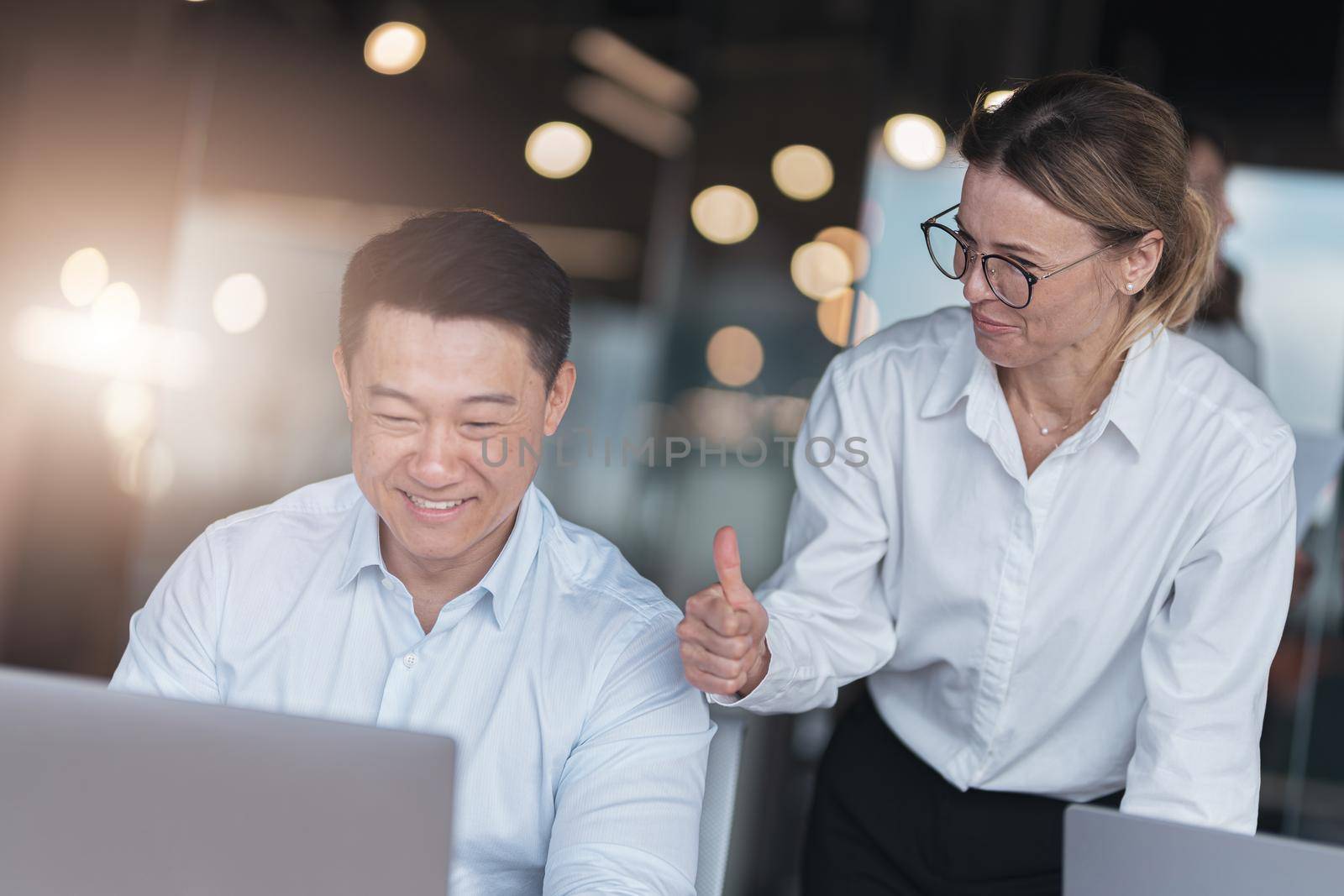 Picture of excited happy emotional colleagues in office working with computer at office by Yaroslav_astakhov