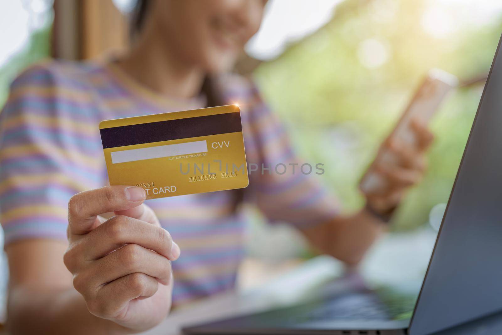 Online Shopping and Internet Payments, Portrait of Beautiful Asian women are using their credit cards and mobile phones to shop online or conduct errands in the digital world.