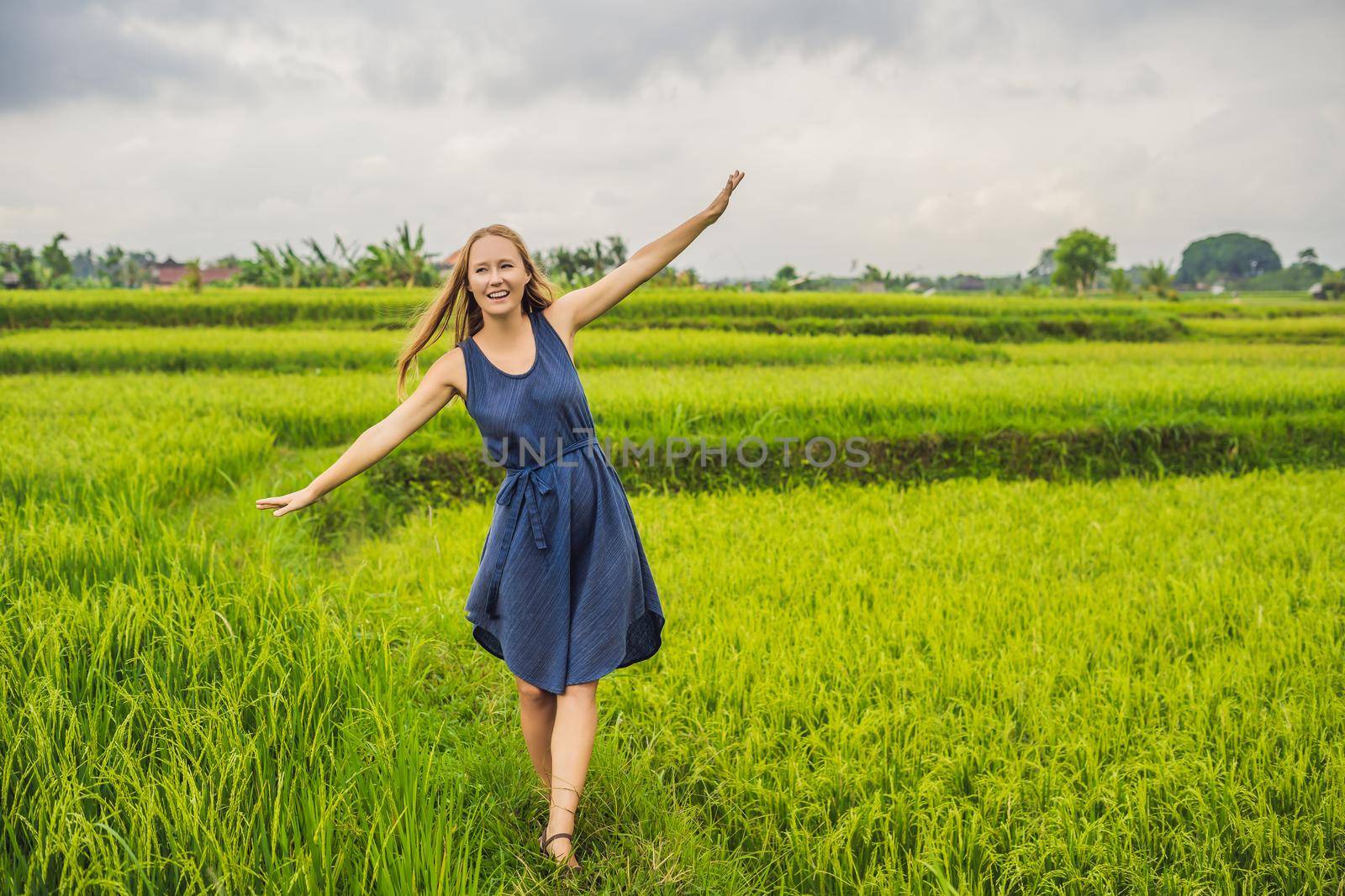 Young woman on Green cascade rice field plantation. Bali, Indonesia.