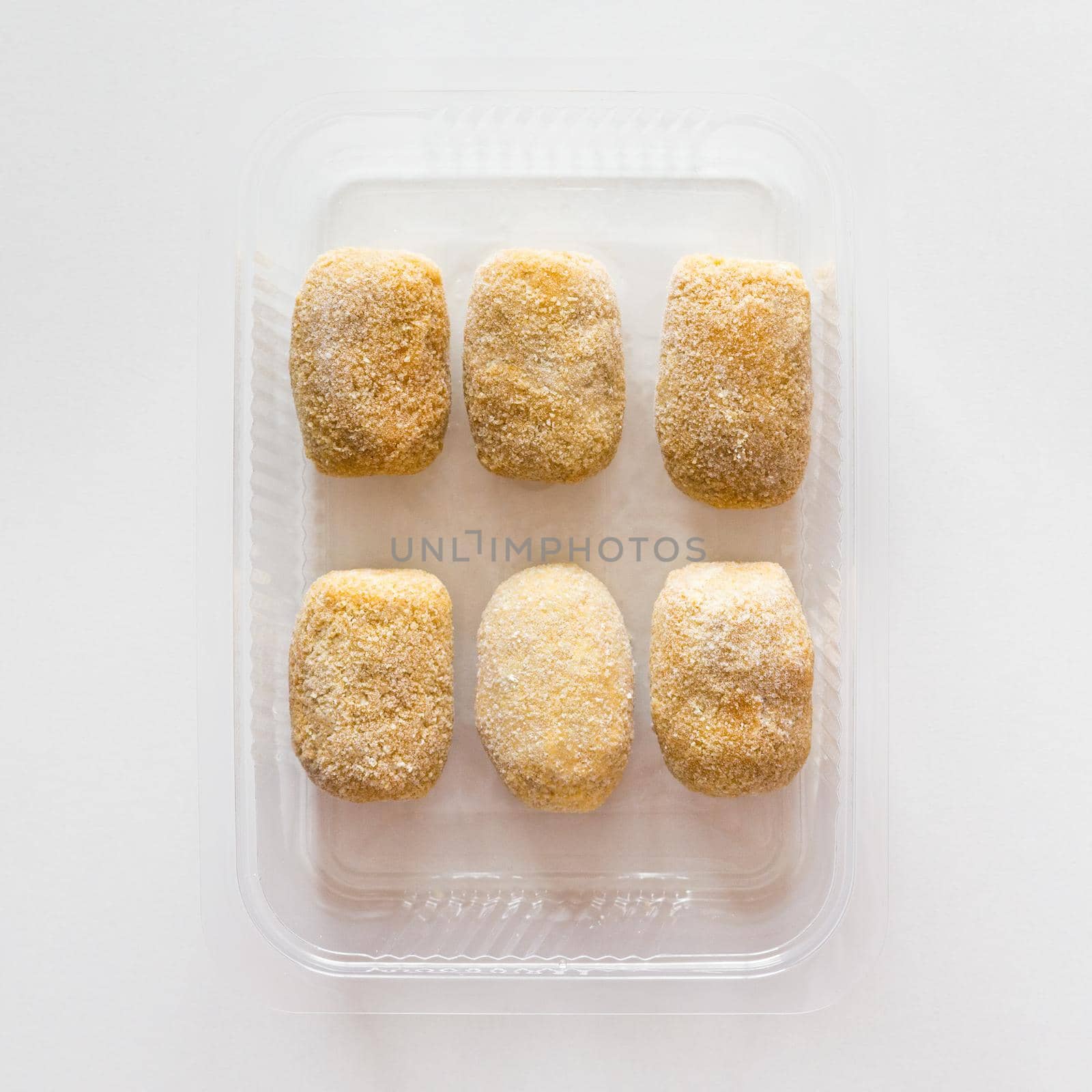 Homemade frozen croquettes in transparent tray. Mediterranean and spanish cuisine. Preserved food for sale. by apavlin