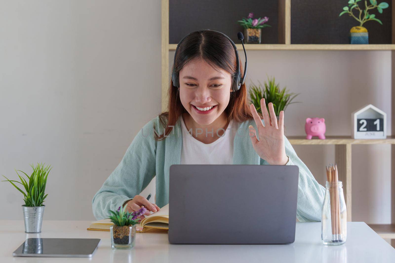 Smiling Asian attentive student studying online class. e-learning education concept