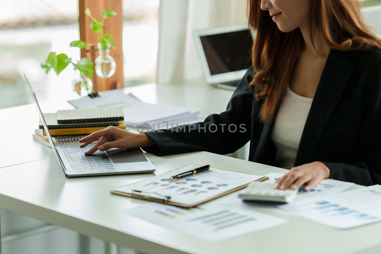 Businesswoman in having a video call on laptop while discussion with business partner during work from home