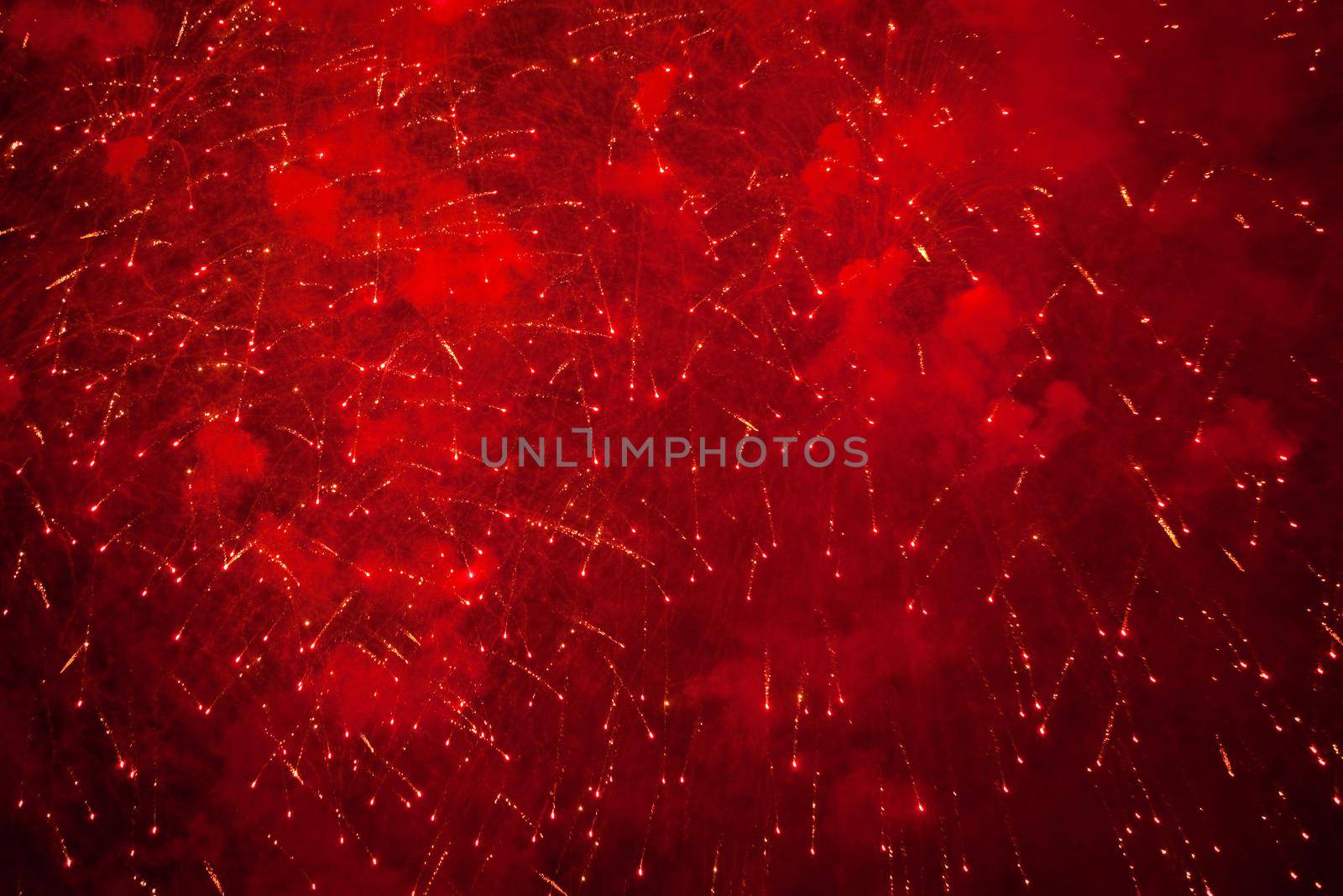Red and orange sparks of fireworks in the dark sky by TashaRo