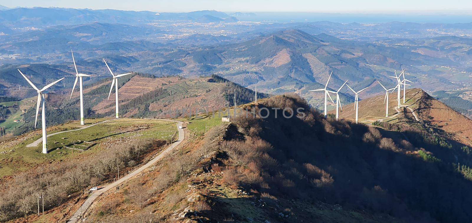 wind farm located on top of a mountain by barcielaphoto
