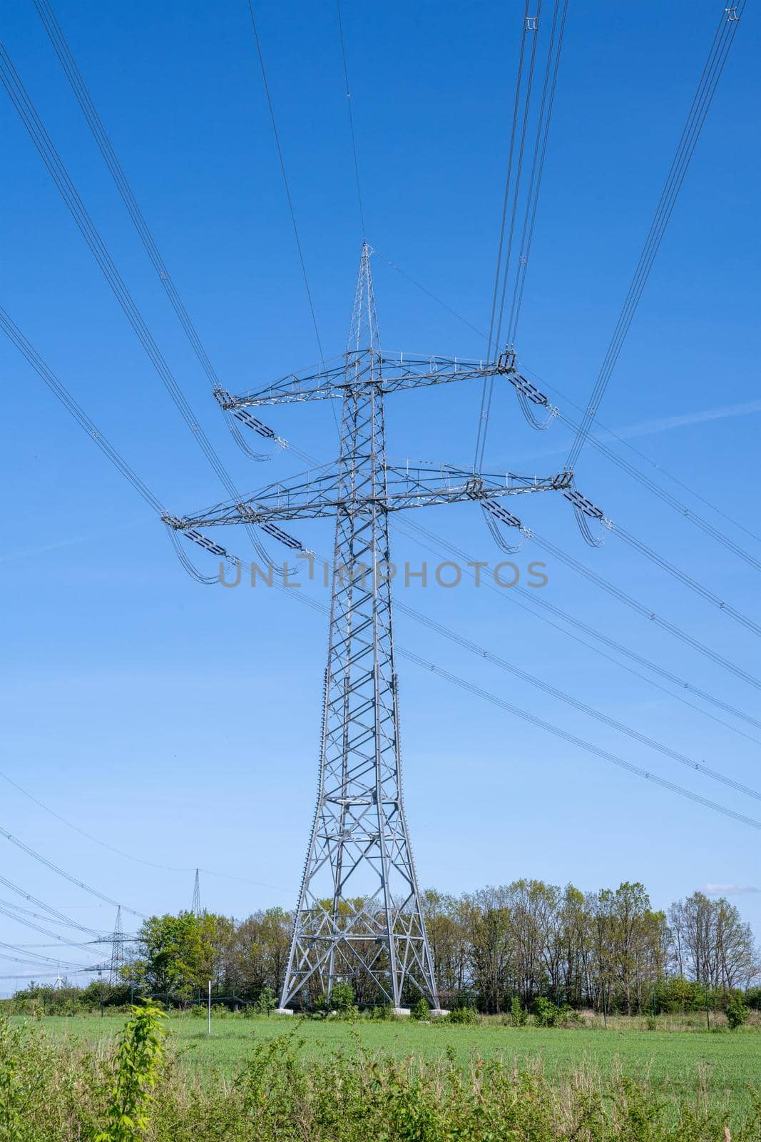 An electricity pylon with power lines seen in Germany