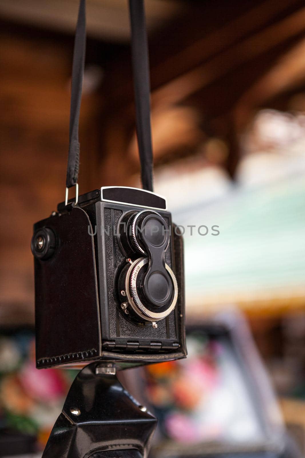 The old Soviet medium format film camera hanging on a belt at a flea market