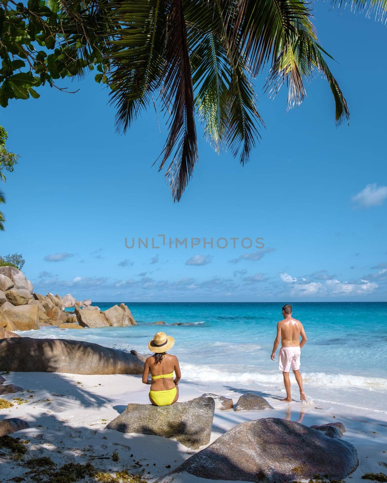 Anse Georgette Praslin Seychelles, young couple men and woman on a tropical beach during a luxury vacation in the Seychelles. Tropical beach Anse Georgette Praslin Seychelles by fokkebok