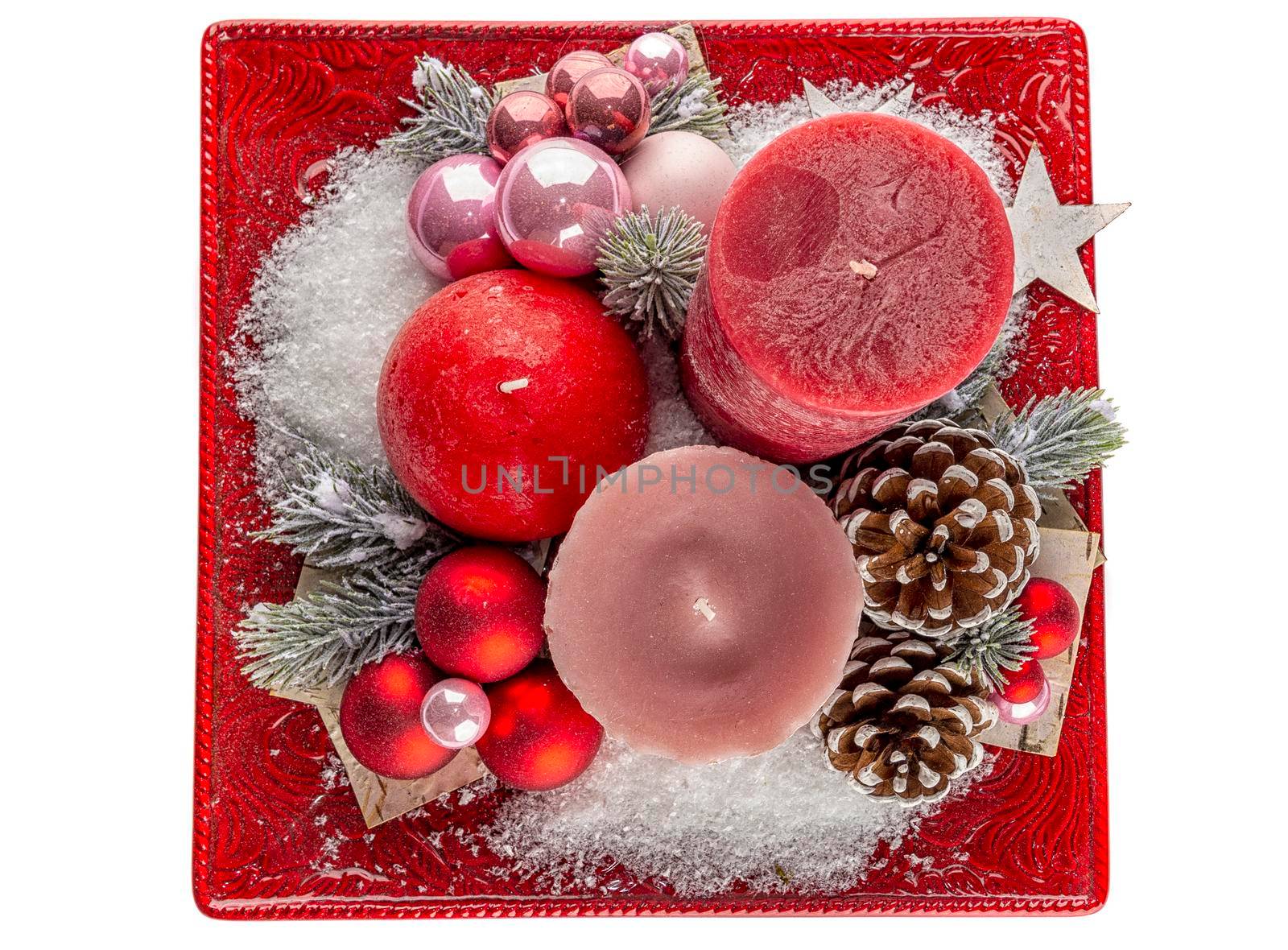 Holiday decoration with candles, cones and snow.Top view. Isolated on white
