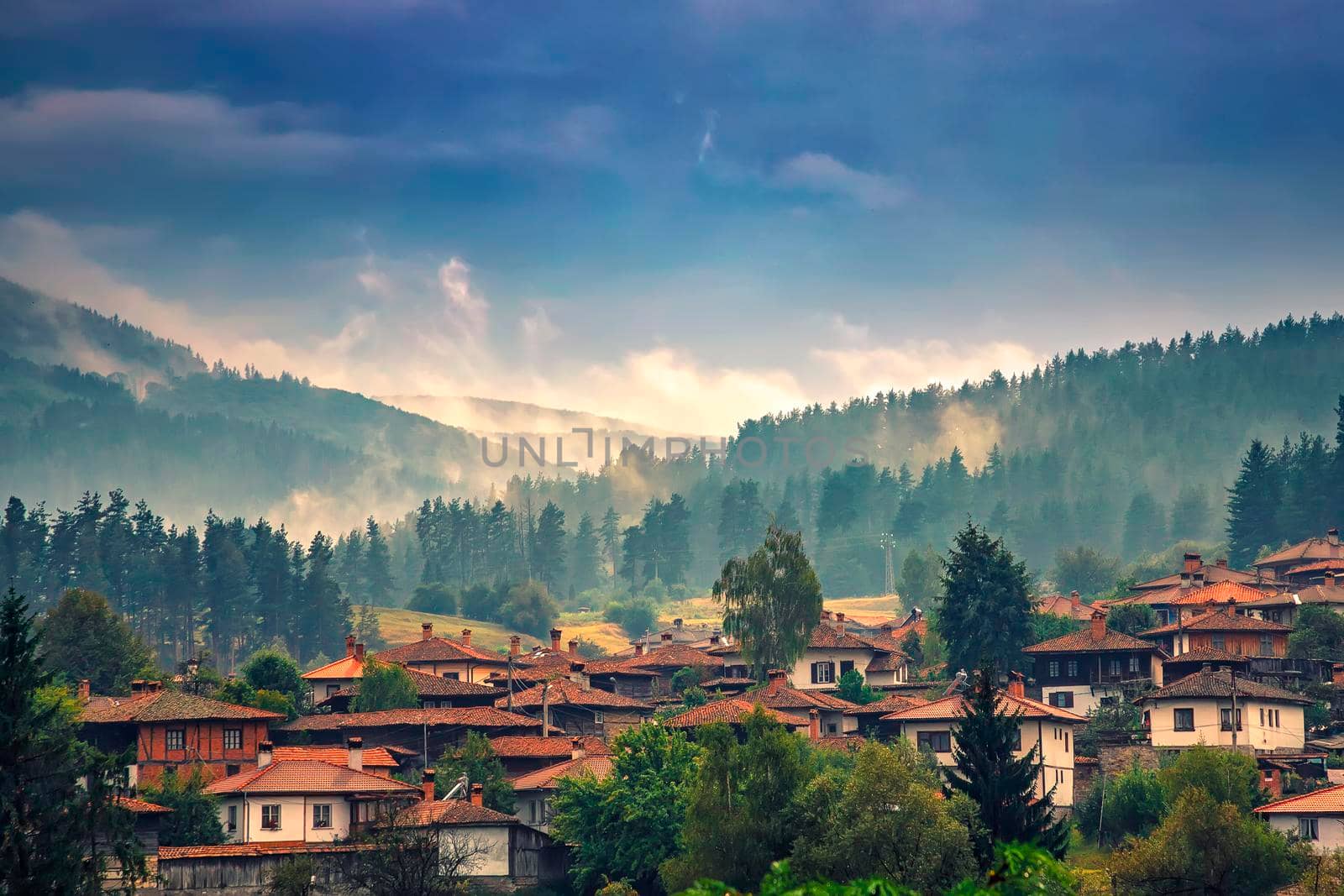Misty landscape mountain view over the beautiful wooden houses of the village
