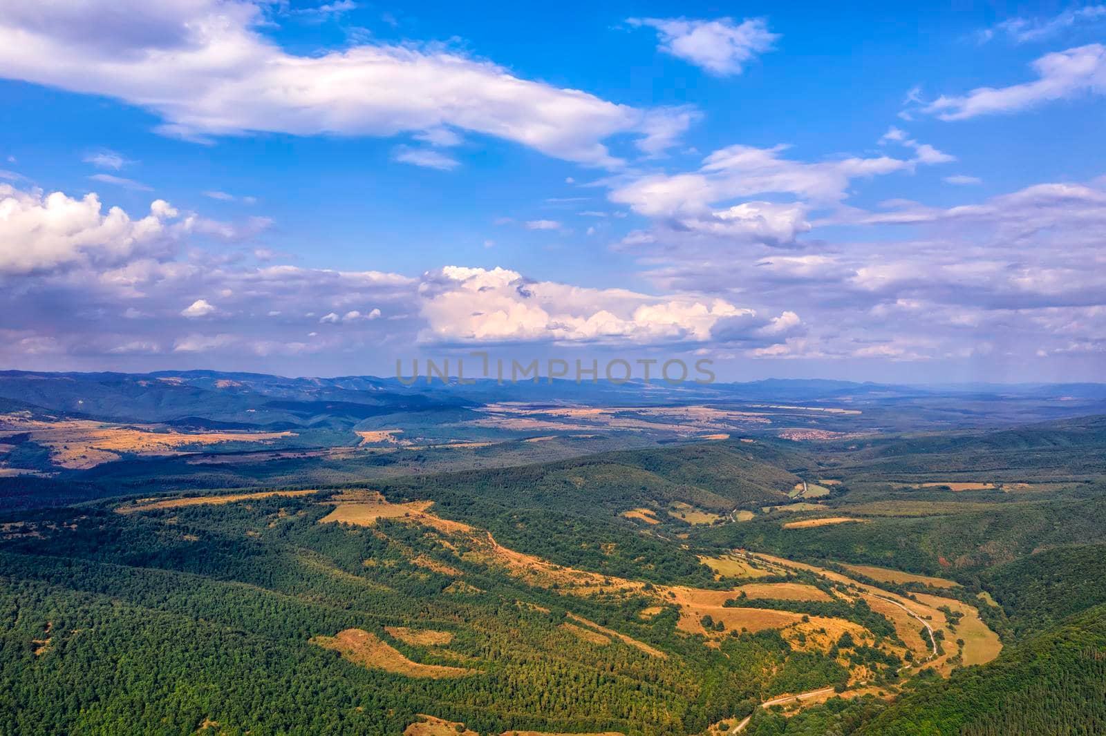 Panoramic Drone Aerial View view of mountain peaks. Hilltops covered with forest. Green nature background aerial view mountain landscape.