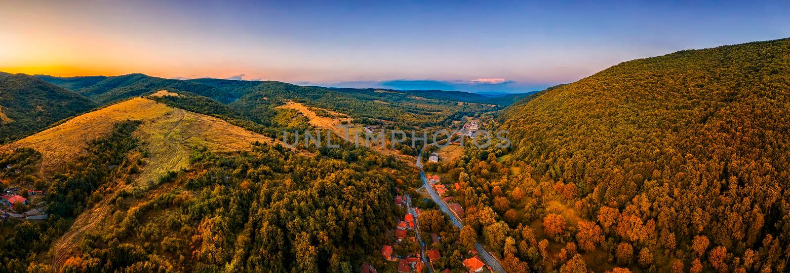 Panoramic Drone Aerial View view of mountain peaks and road between them. Autumn landscape by EdVal