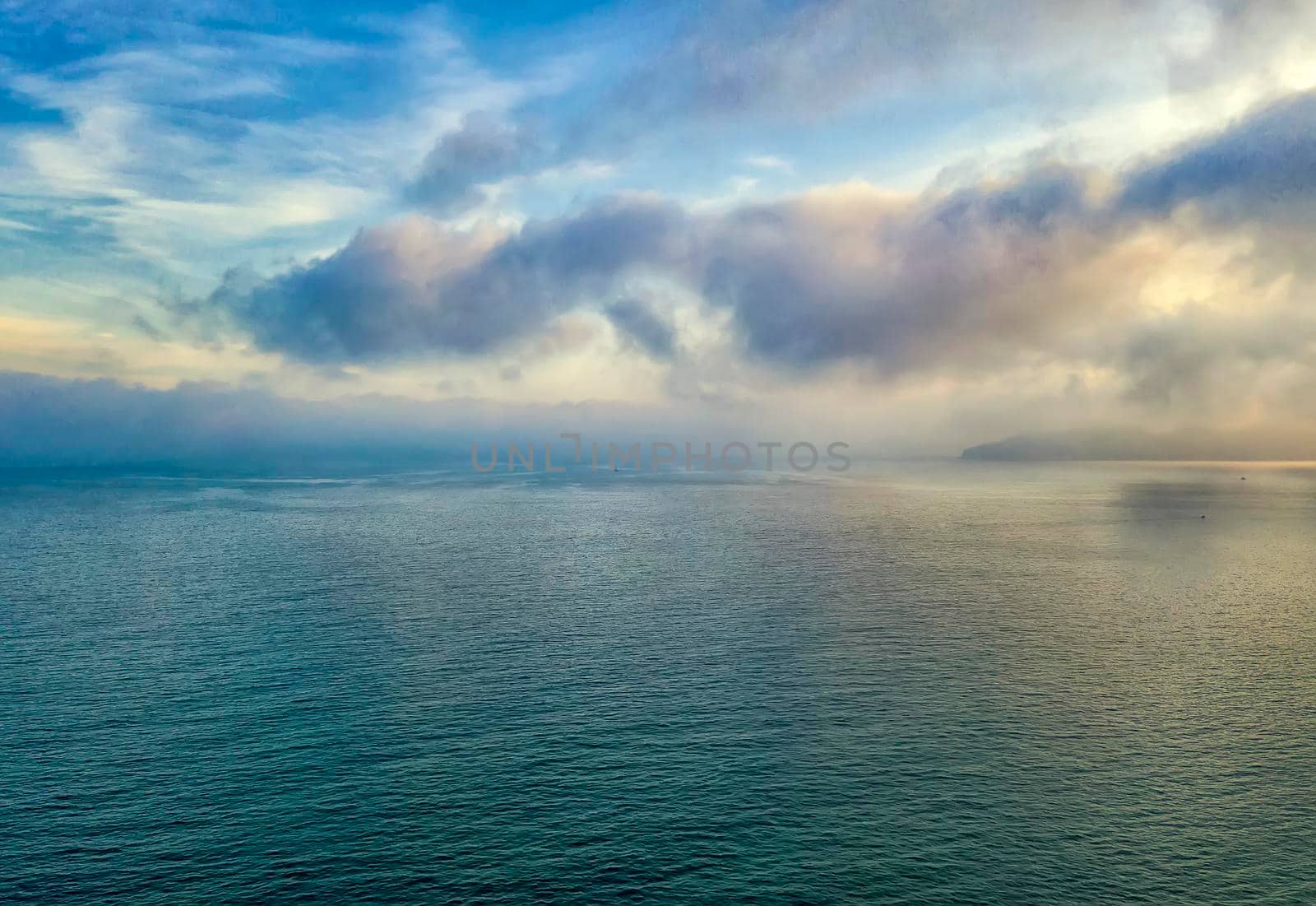 Exciting sunset. Beautiful colorful clouds over the sea.