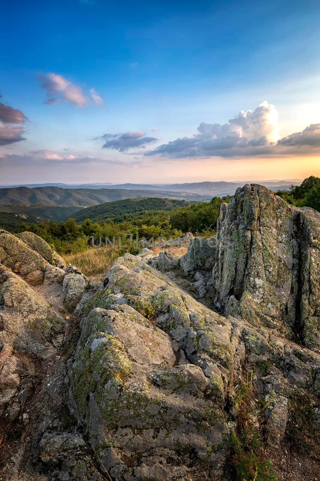 Amazing rocks on the edge of a mountain. Beautiful summer landscape  of mountains at sunset by EdVal