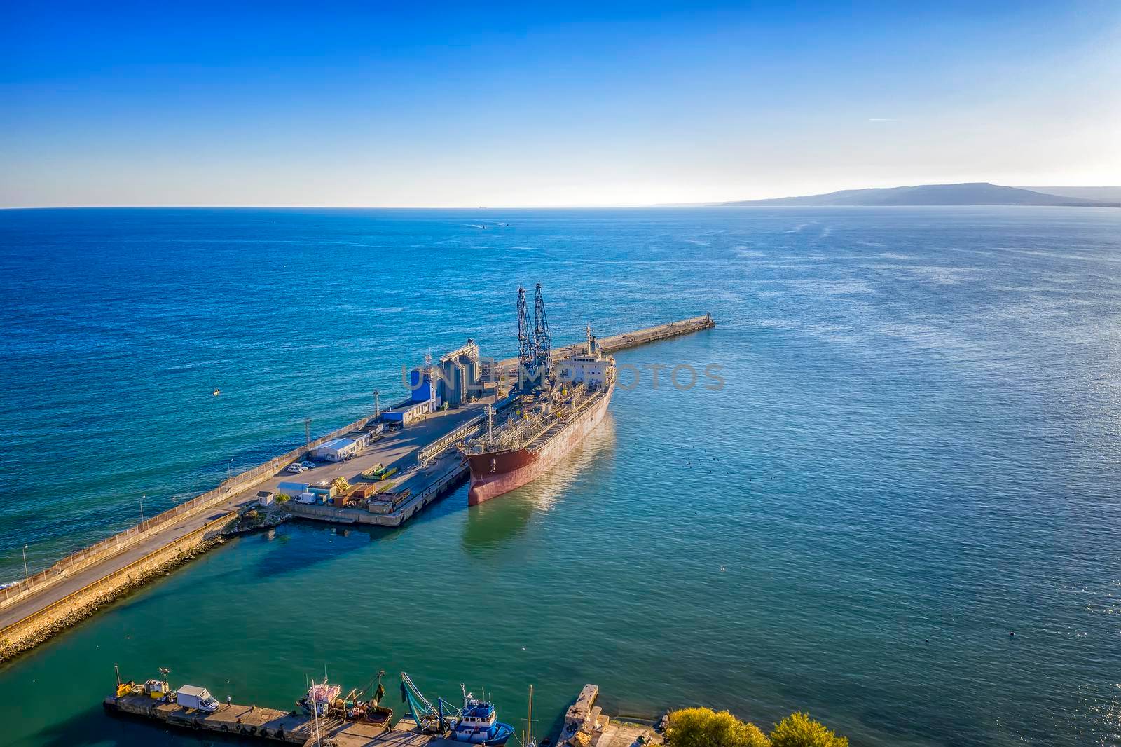A tanker of the city port. Aerial view from a drone. Concept export ship