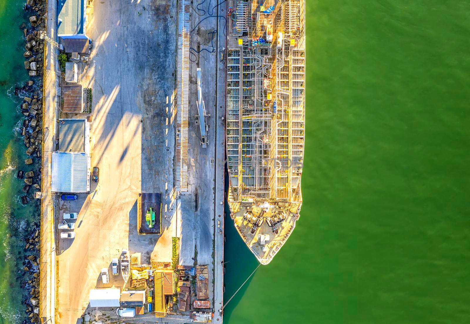 A part of a tanker of the city port. Aerial top view from a drone. Concept export ship