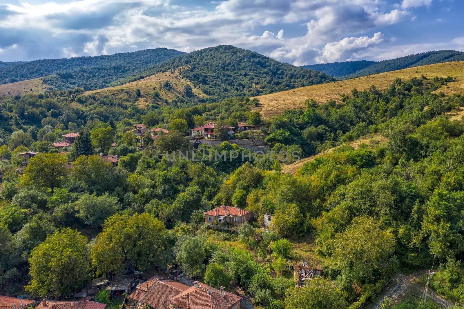 Panoramic Drone Aerial View view of mountain peaks. Hilltops covered with forest. Green nature background aerial view mountain landscape.