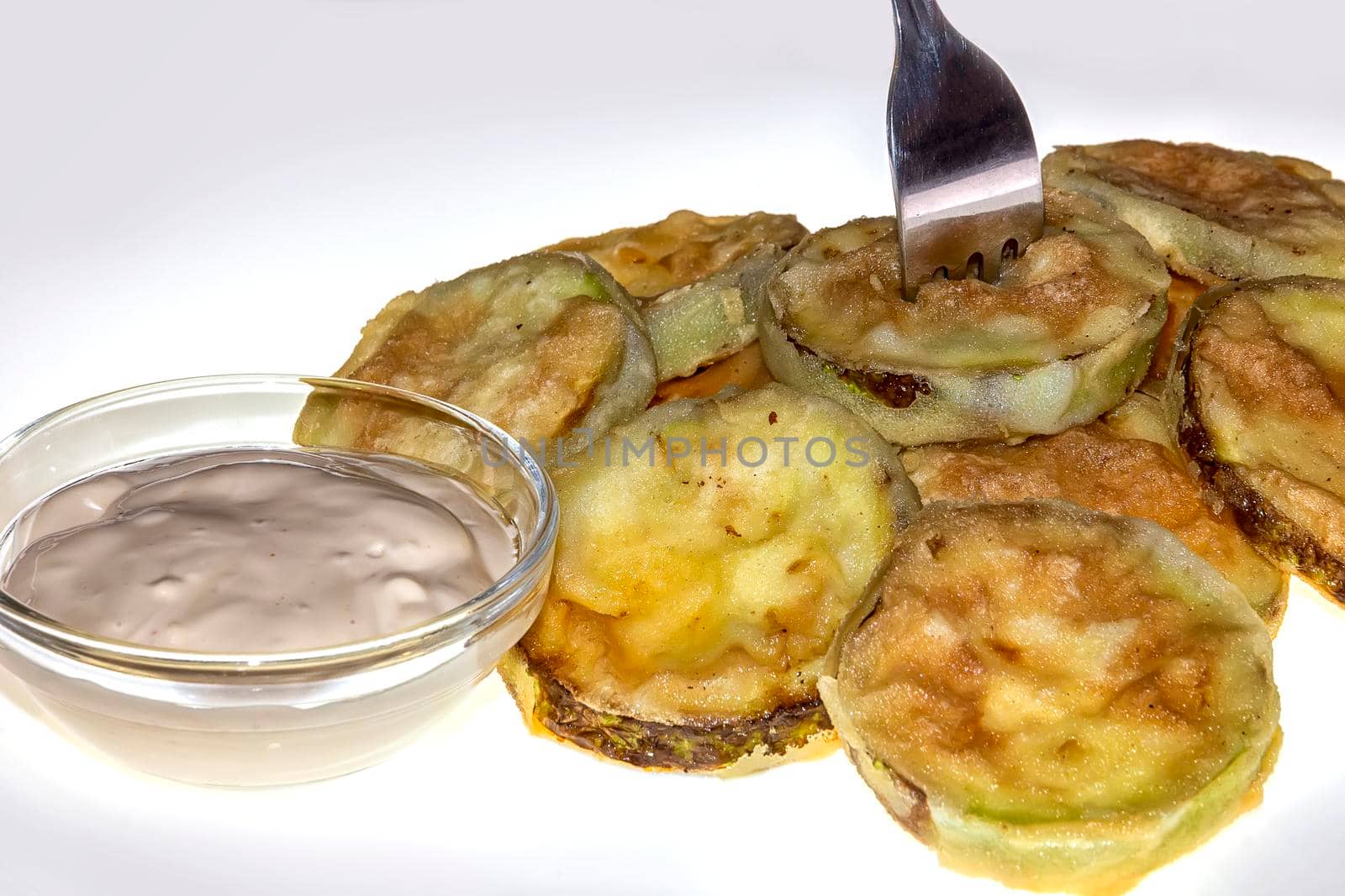 Homemade Zucchini Fries on a plate with a c fork and sauce. Fast Food Concept