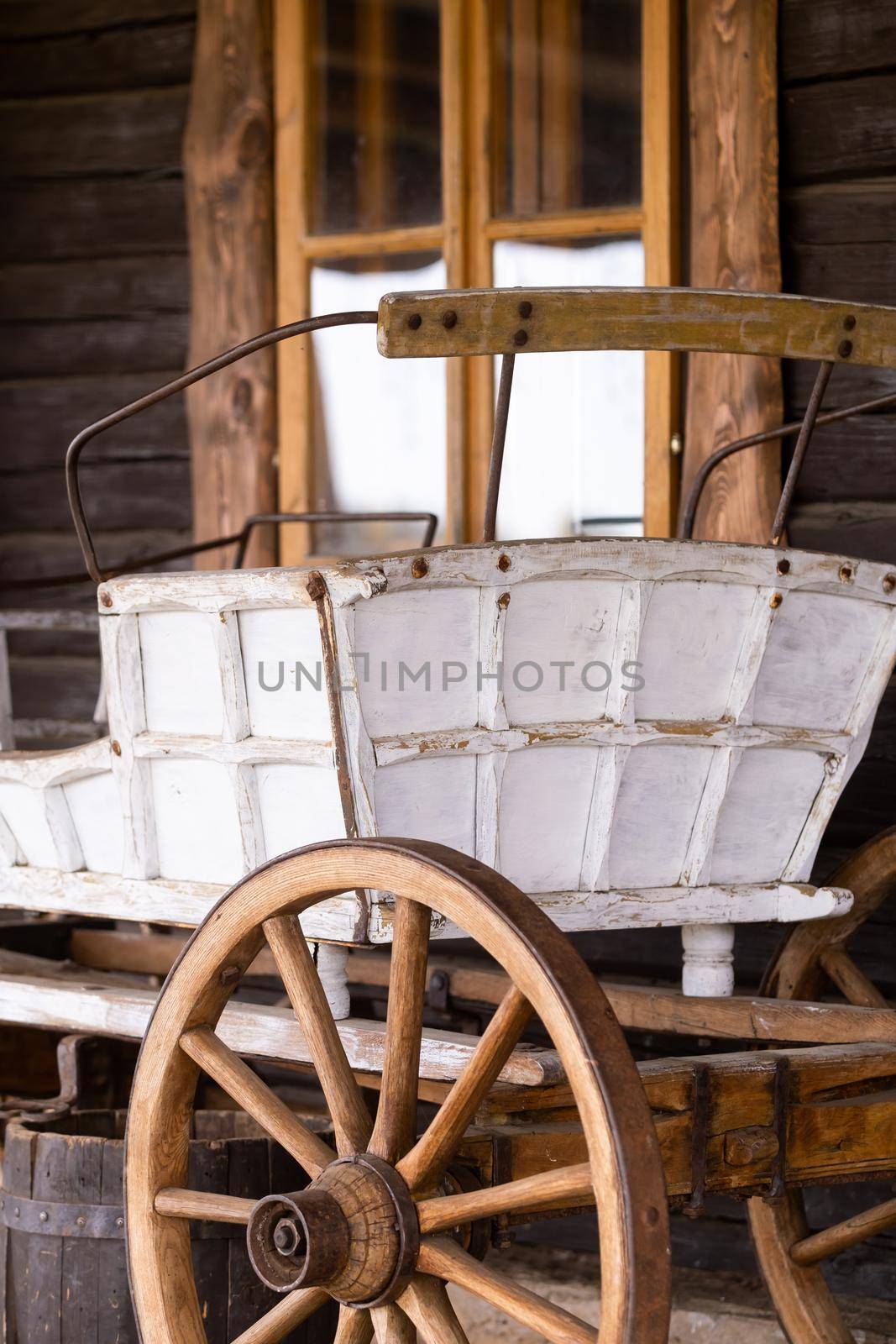 An empty antique carriage stands on a ranch in the wild West by Lobachad