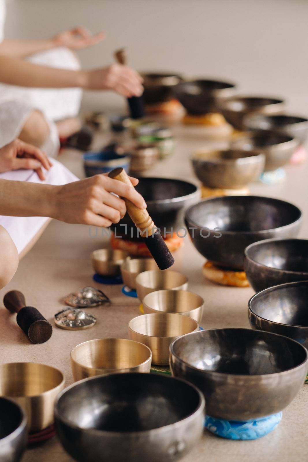 Close-up of a Tibetan singing bowl in your hands - Translation of mantras: transform your impure body, speech and mind into a pure exalted body, speech and mind of a Buddha by Lobachad