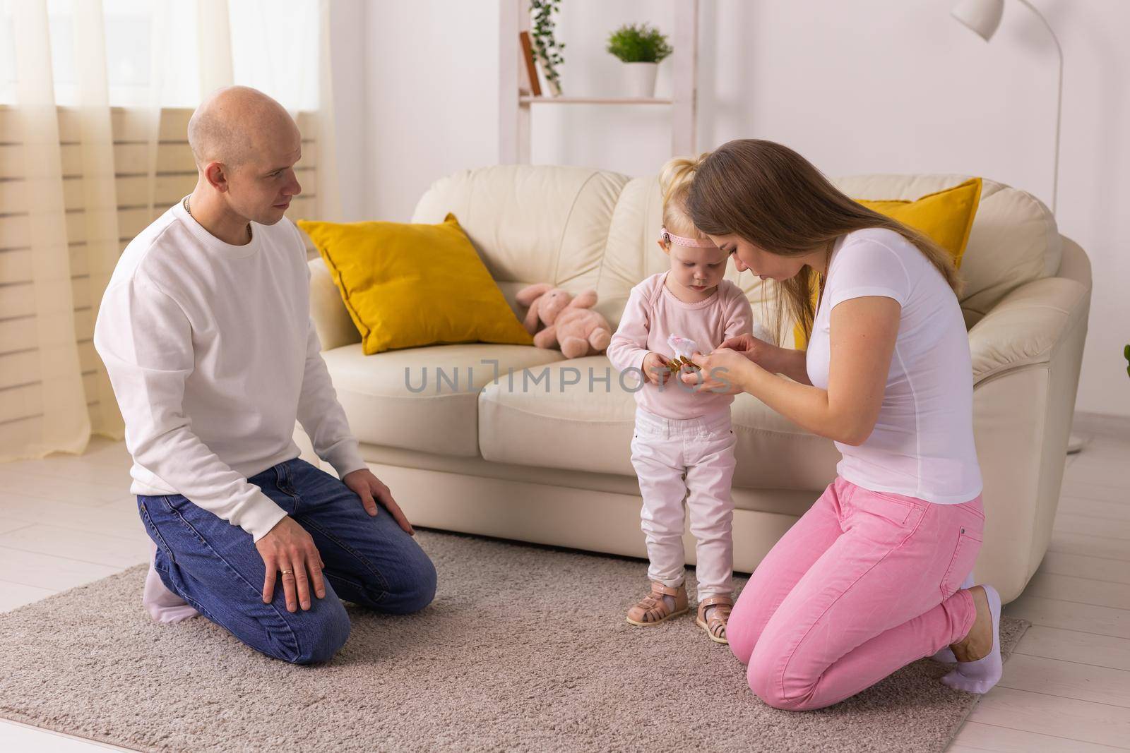 Happy child girl with cochlear implant having fun with her family - hearing aid for deaf and innovative health technology concept by Satura86