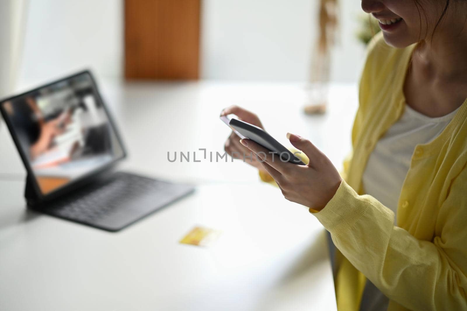 Happy young woman making shopping online, payment online on her smart phone.