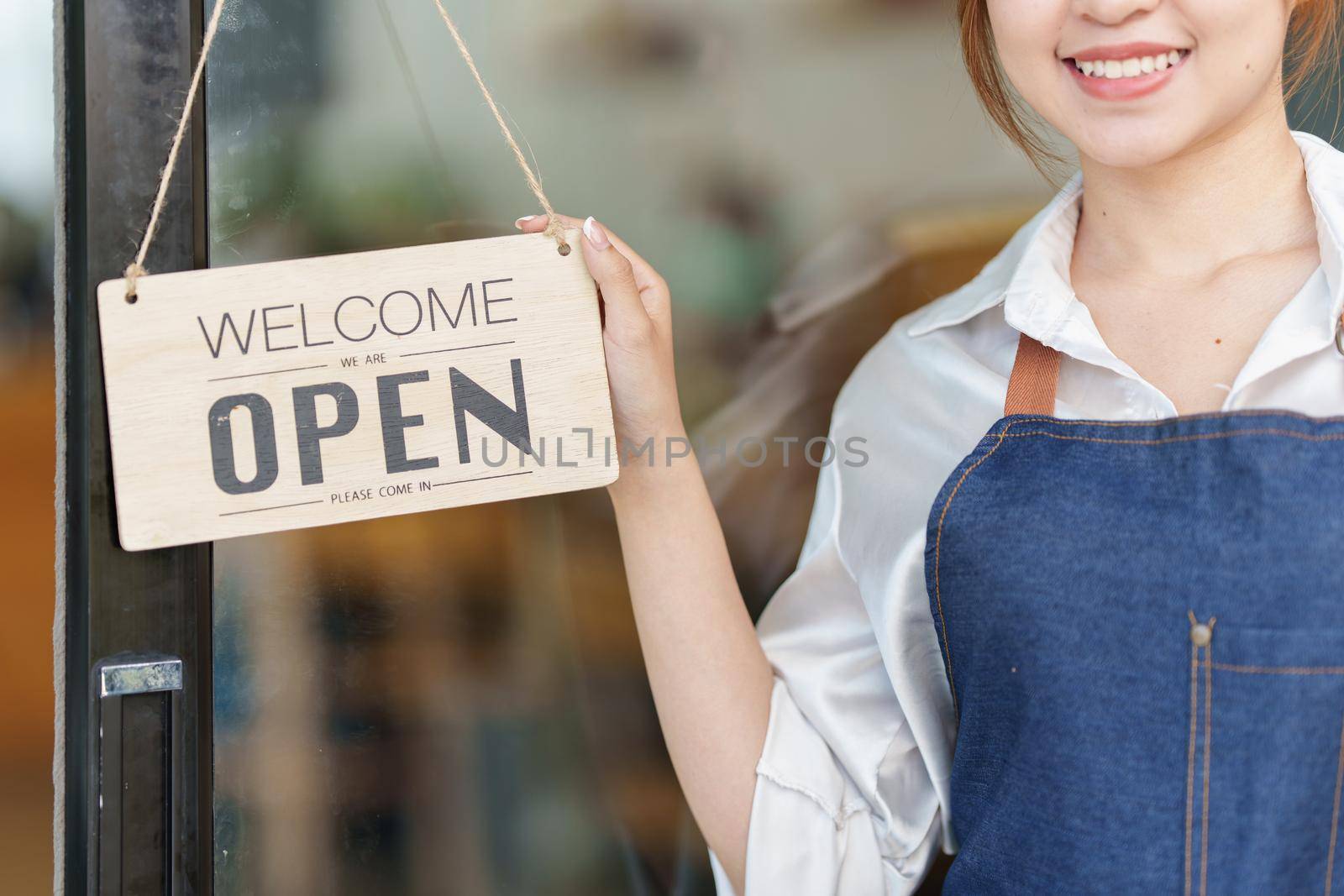 Asian Barista cafe owner smile while cafe open. SME entrepreneur seller business concept