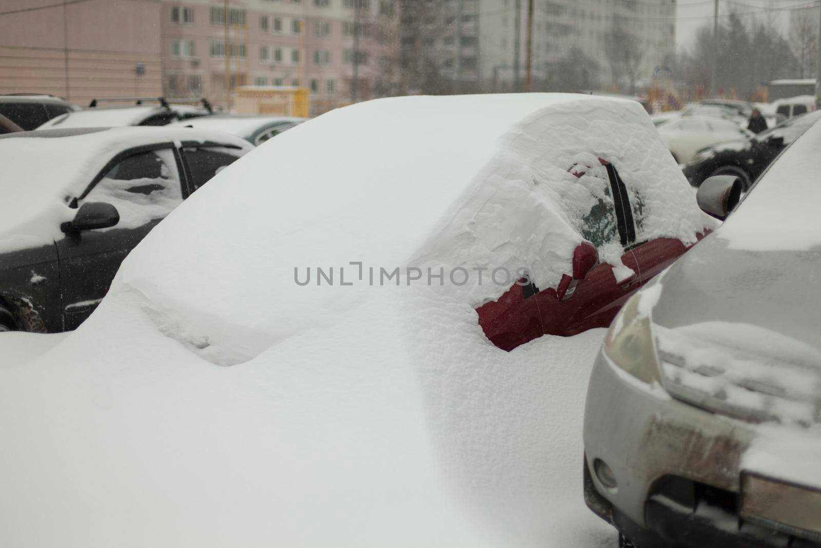 Frozen cars in parking lot. Cars were covered with snow. After snowstorm. by OlegKopyov