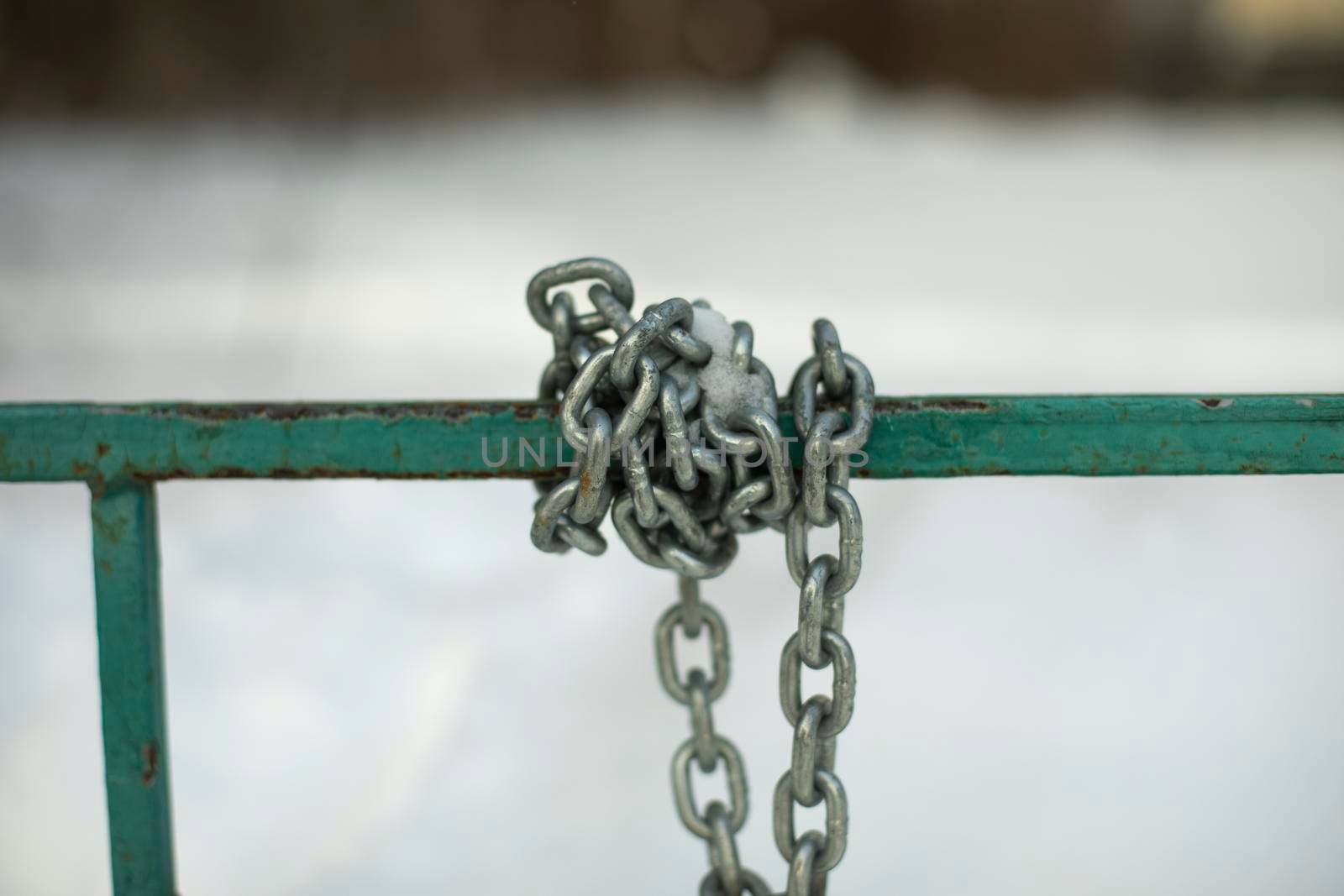 Steel chain is wound on handrail. Chain to protect bike. Links are interlocked.