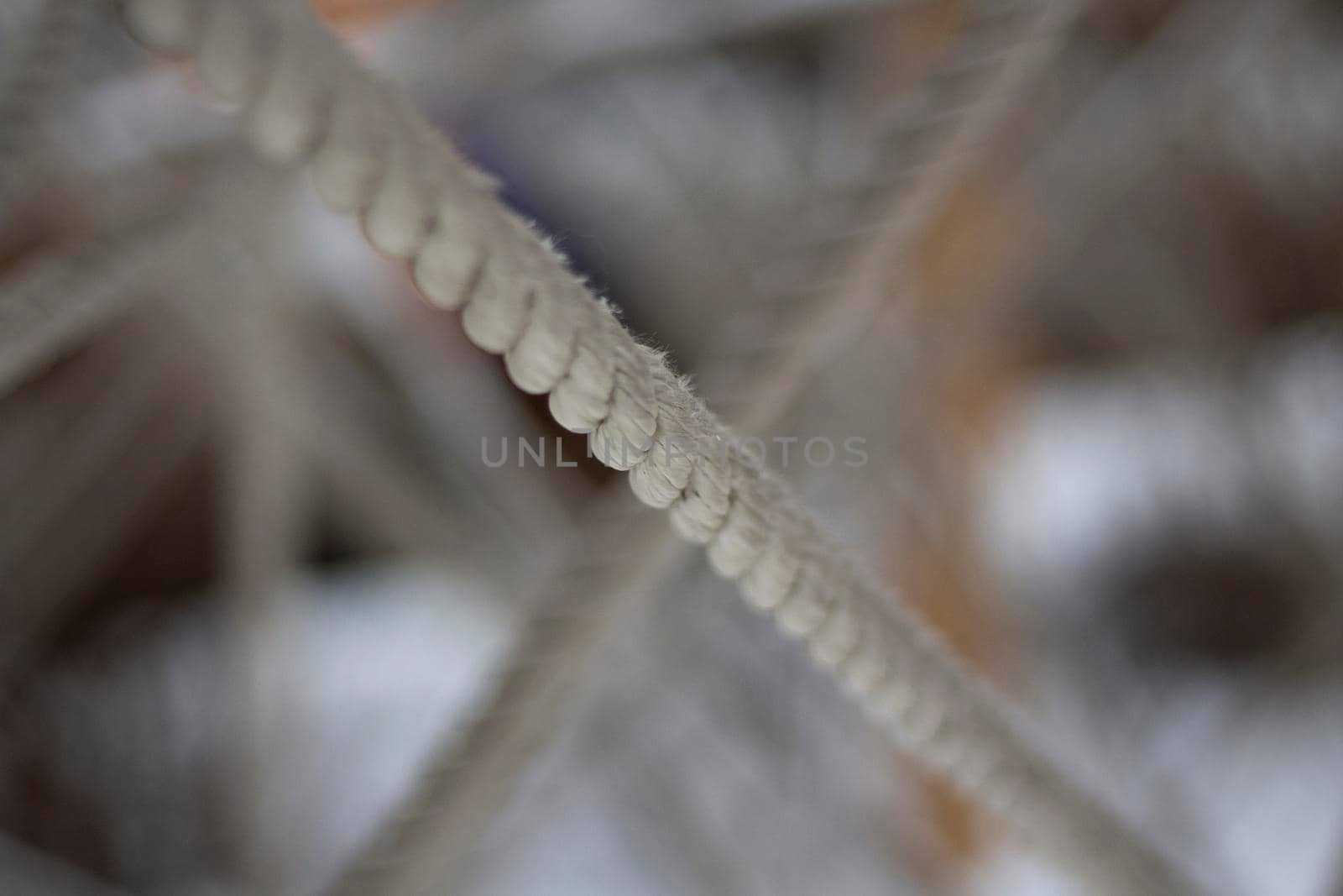 Tangled ropes. Crossing ropes. Texture of thread in snow. Labyrinth of ropes. Details of playground.