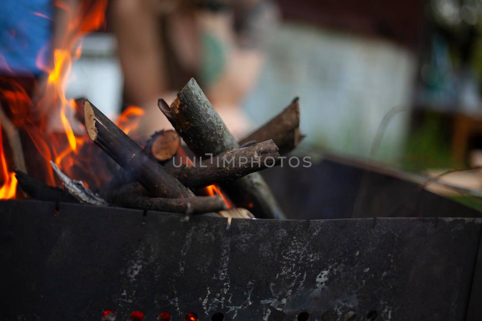 Dry branches burn. Picnic in nature. Coal preparation. Burning firewood.