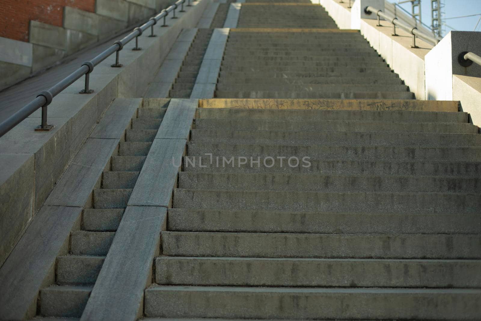 Long staircase up. Architecture details. Steps and ramp for lifting stroller.