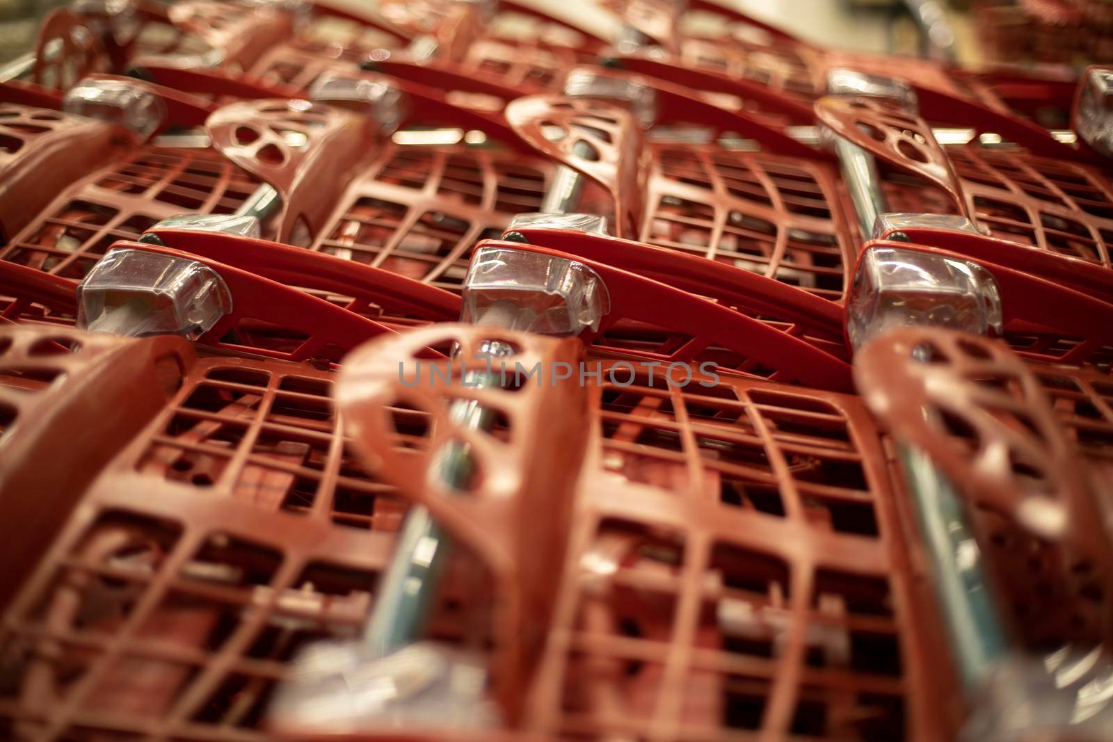 Baskets for products. Supermarket details. Red plastic containers.
